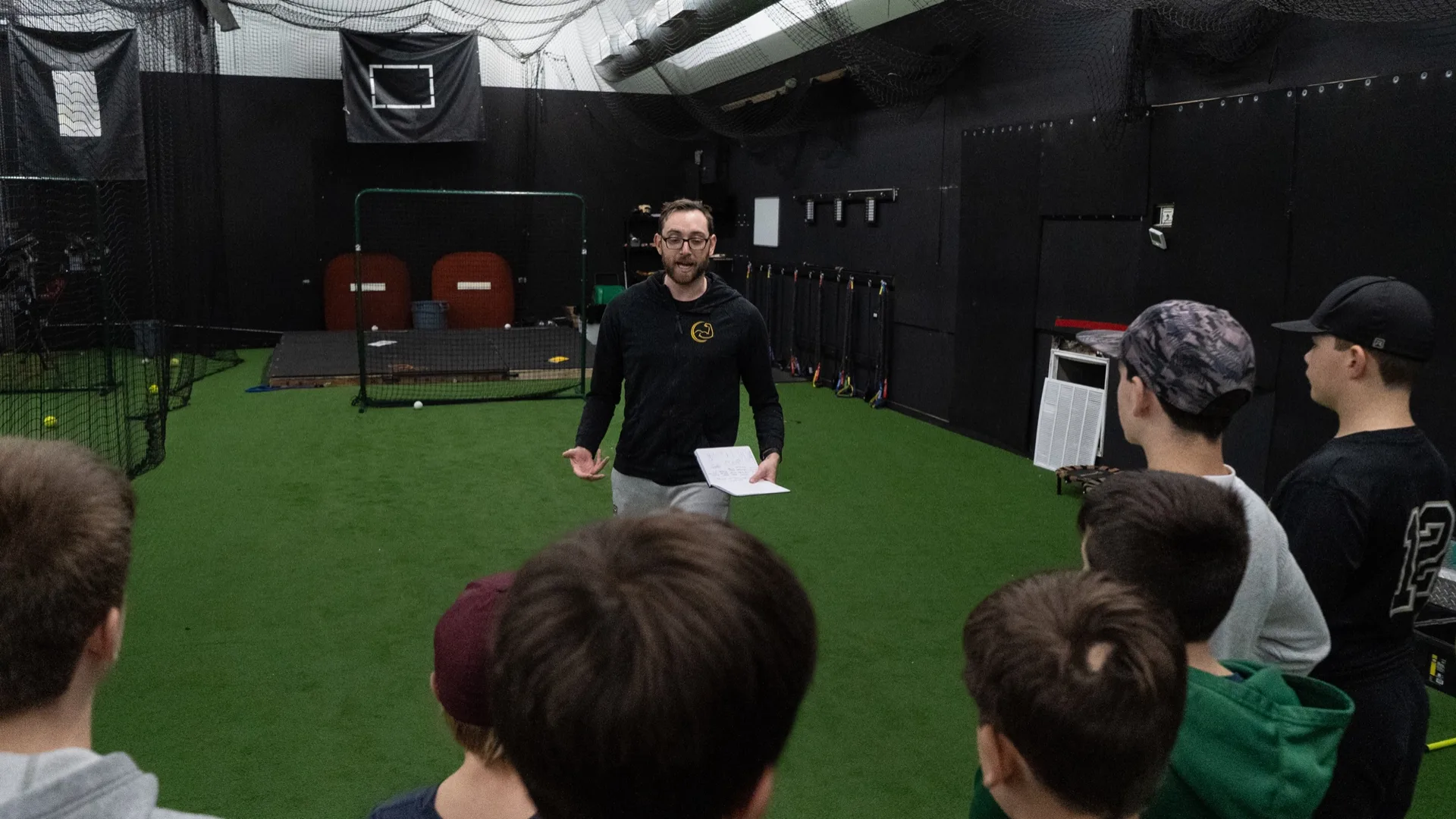 Cam MacDonald coaching youth baseball players at Powerhouse Sports NH