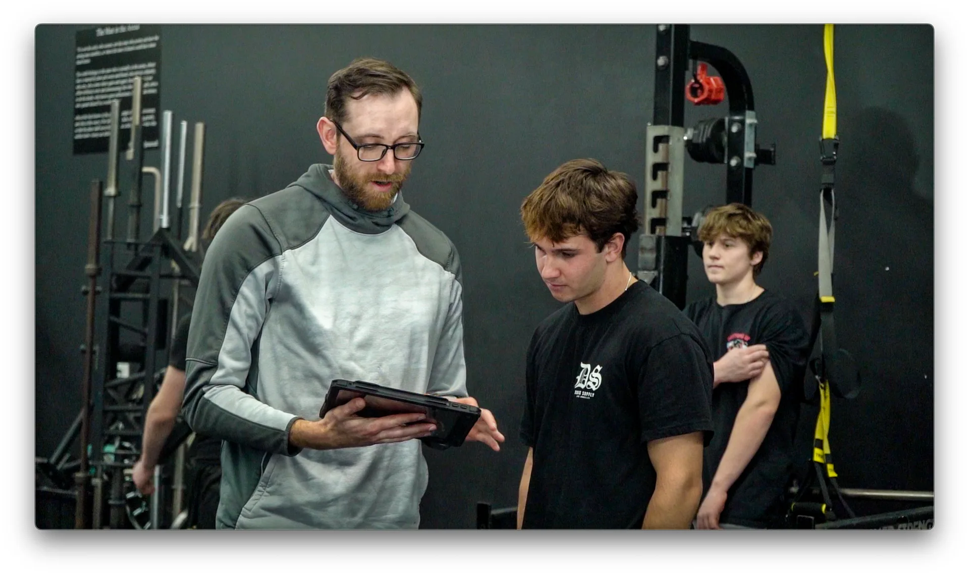 Coach reviewing data with athletes at Powerhouse